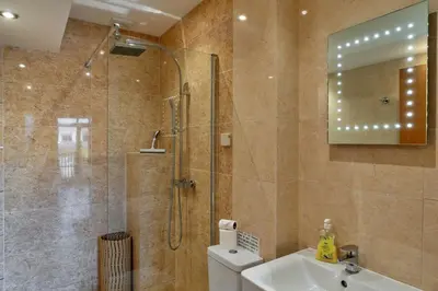 a bathroom with a shower and a toilet and a sink at Finest Retreats - Trippet Cottage at Bodmin Moor in Saint Breward