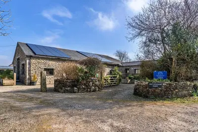 a house with solar panels on the roof at Finest Retreats - Trippet Cottage at Bodmin Moor in Saint Breward