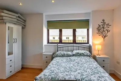 a bedroom with a bed and a window at Finest Retreats - Trippet Cottage at Bodmin Moor in Saint Breward