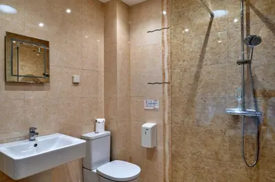 a bathroom with a shower and a toilet and a sink at Finest Retreats - Jubilee Cottage at Bodmin Moor in Saint Breward
