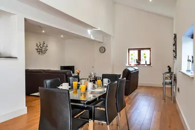 a dining room and living room with a table and chairs at Finest Retreats - Jubilee Cottage at Bodmin Moor in Saint Breward