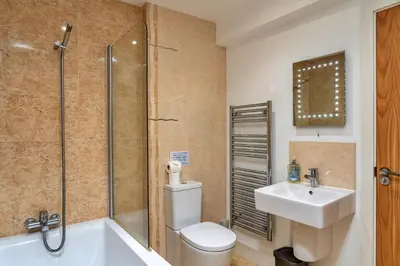 a bathroom with a toilet and a sink and a shower at Finest Retreats - Jubilee Barn Cottage at Bodmin Moor in Saint Breward