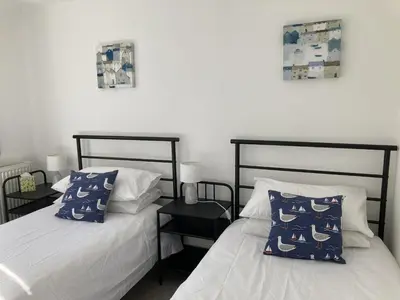 two beds sitting next to each other in a bedroom at Flat 4, 10 Porthminster Terrace in St Ives