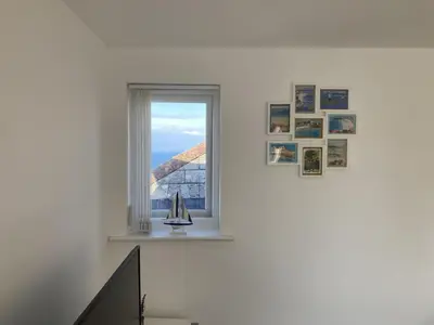 a room with a window with a sailboat in it at Flat 4, 10 Porthminster Terrace in St Ives
