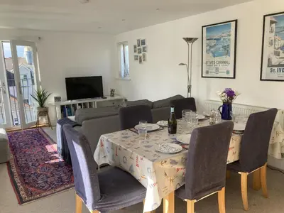 a living room with a table and a couch at Flat 4, 10 Porthminster Terrace in St Ives