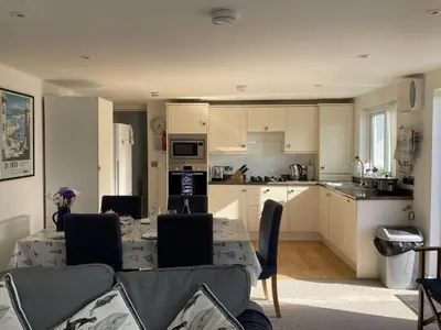 a kitchen with a table and chairs in a room at Flat 4, 10 Porthminster Terrace in St Ives