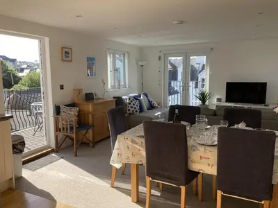 a living room with a table with chairs and a couch at Flat 4, 10 Porthminster Terrace in St Ives