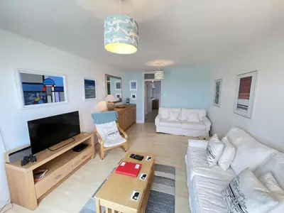 a living room with a couch and a tv at 51-52 Carrack Widden in St Ives