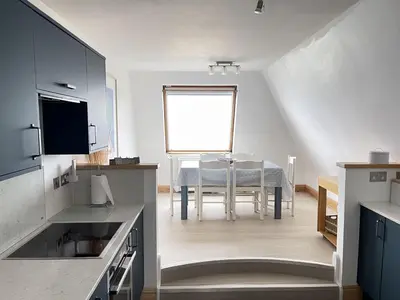 a kitchen with a table and a dining room at 51-52 Carrack Widden in St Ives