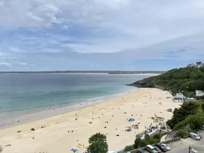 a beach with a lot of people on it at 51-52 Carrack Widden in St Ives