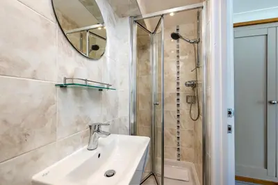 a bathroom with a sink and a shower at Blue Mist House in St Ives
