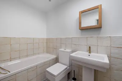a bathroom with a toilet and a sink and a mirror at 5 Mermaid Court in Newquay