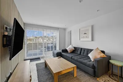 a living room with a couch and a table at 5 Mermaid Court in Newquay