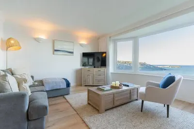 a living room with a couch and a tv at Flat 17, The Stones in St Ives