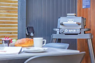 a coffee machine sitting on top of a table at Lerryn Lodge, The Vale, Cornwall in Looe