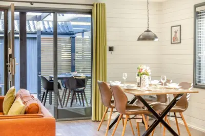 a dining room with a table and chairs at Lerryn Lodge, The Vale, Cornwall in Looe