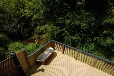 a urinal sitting on top of a wooden deck at Cardinham Lodge, The Vale, Cornwall in Looe