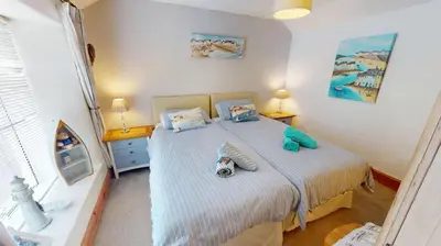 a bedroom with a bed with two pillows at Hayle Saffron Cottage 2 Bedrooms in Hayle
