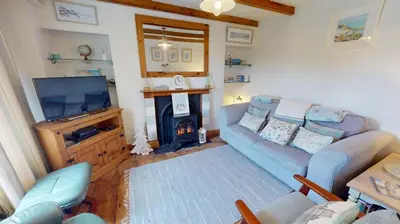 a living room with a couch and a fireplace at Hayle Saffron Cottage 2 Bedrooms in Hayle