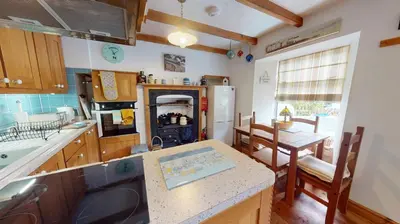 a kitchen with a sink and a counter top at Hayle Saffron Cottage 2 Bedrooms in Hayle