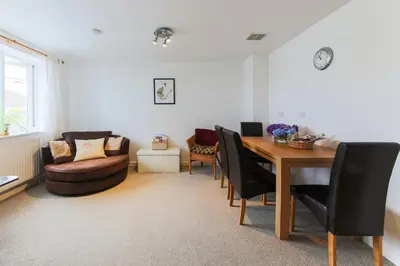 a dining room with a table and chairs and a couch at 5 Bedroom House with Sea Views in Penryn