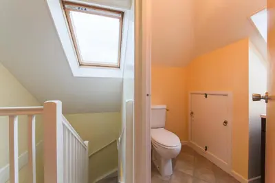 a bathroom with a toilet and a skylight at 5 Bedroom House with Sea Views in Penryn