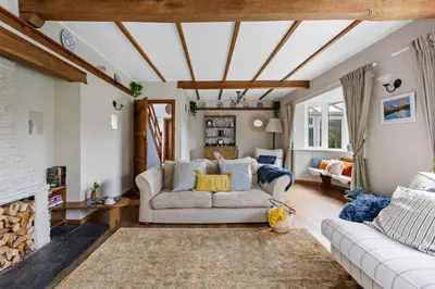 a living room with a couch and a fireplace at Blue Haze - Family accommodation with private beach access in Charlestown