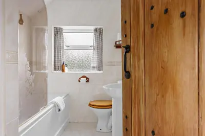 a bathroom with a toilet and a sink at Blue Haze - Family accommodation with private beach access in Charlestown