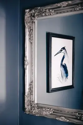 a framed picture of a bird in a mirror at Smarties Guest House in Newquay
