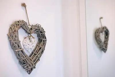 two heart shaped wicker hearts hanging on a wall at Smarties Guest House in Newquay