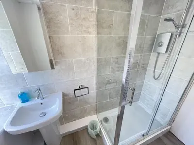 a bathroom with a shower and a sink at Lower Deck in St Ives