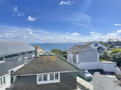 a house with a car parked in a parking lot at The Lookout in St Ives