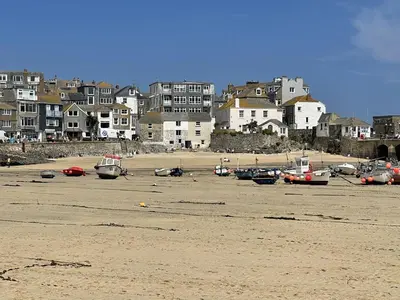 a group of boats sitting on the sand on a beach at 3 Sunnyside - amazing harbour views in St Ives