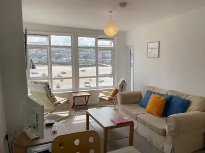 a living room with a couch and a table at 3 Sunnyside - amazing harbour views in St Ives