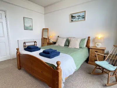 a bedroom with a bed with blue towels on it at An Marghty in St Ives