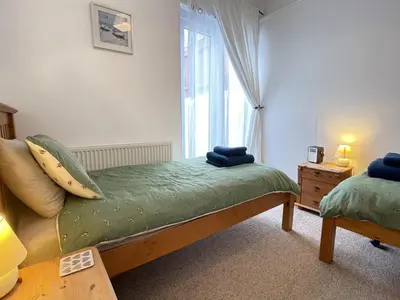 a bedroom with a bed and a window at An Marghty in St Ives
