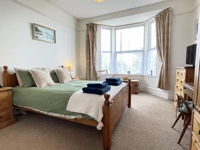 a bedroom with a bed with blue towels on it at An Marghty in St Ives