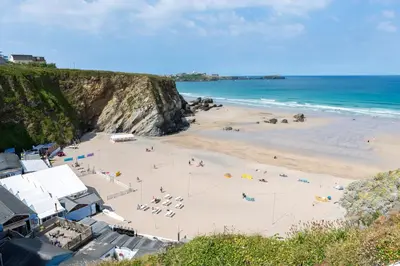 a beach with people on the sand and the ocean at Number 2 in Lusty Glaze, Newquay in Newquay