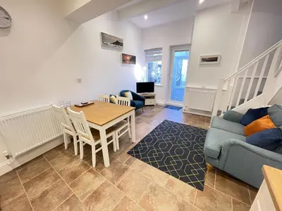a living room with a blue couch and a table at Lower Seaview in St Ives