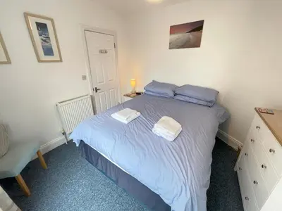 a bedroom with a bed with two towels on it at Lower Seaview in St Ives