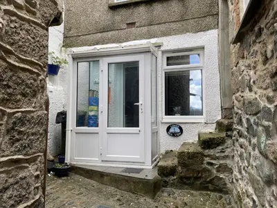 a white door on the side of a building at Lower Seaview in St Ives