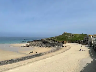 a view of a beach with people on the sand at 26 Piazza - stunning seaviews of Porthmeor beach in St Ives