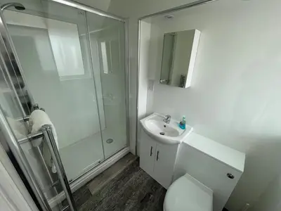 a bathroom with a shower and a toilet and a sink at 26 Piazza - stunning seaviews of Porthmeor beach in St Ives