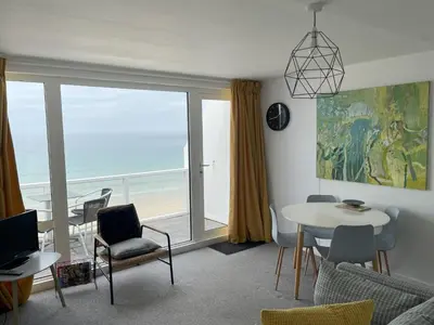 a living room with a view of the ocean at 26 Piazza - stunning seaviews of Porthmeor beach in St Ives