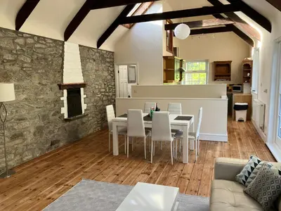 a kitchen and dining room with a table and chairs at Lovely cottage in Penryn centre with parking in Penryn