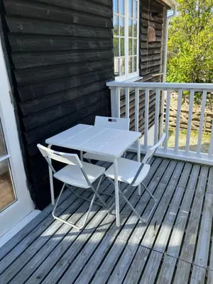a white table and two chairs on a deck at Lovely cottage in Penryn centre with parking in Penryn