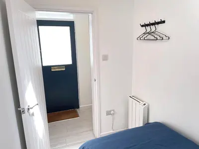 a bedroom with a door leading to a room with a bed at Dolly - a peaceful retreat in St Ives