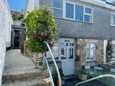 a house with a tree in front of it at Dolly - a peaceful retreat in St Ives