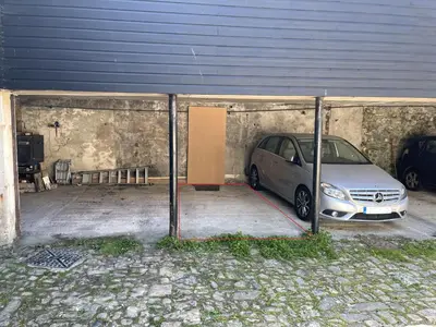 a car parked in a garage next to a building at Dolly - a peaceful retreat in St Ives