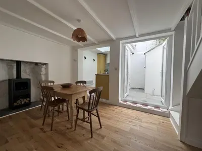 a dining room with a table and chairs and a window at 9 Mount Pleasant in St Ives